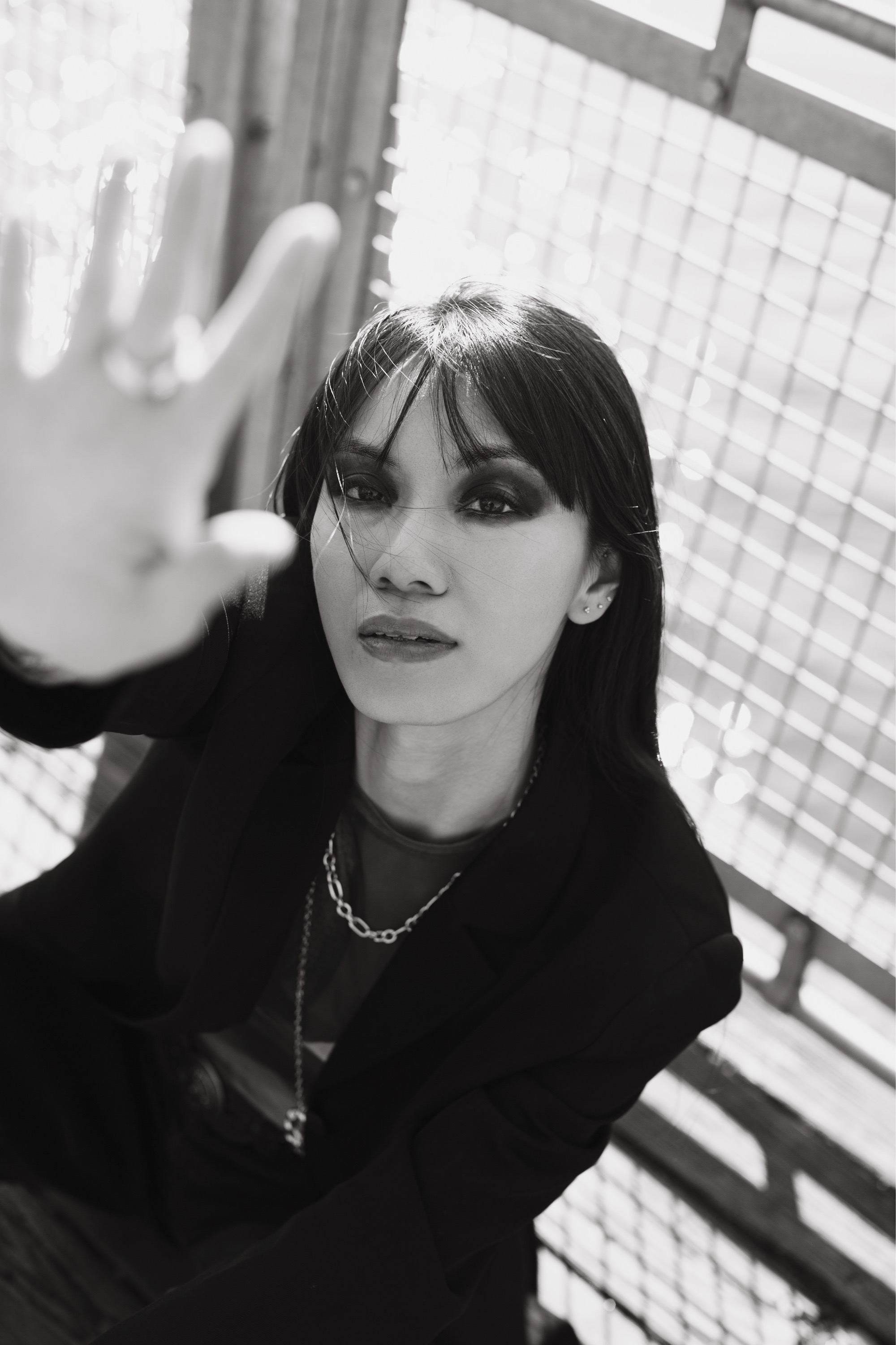 Darin black and white fashion editorial portrait seated waterfront
