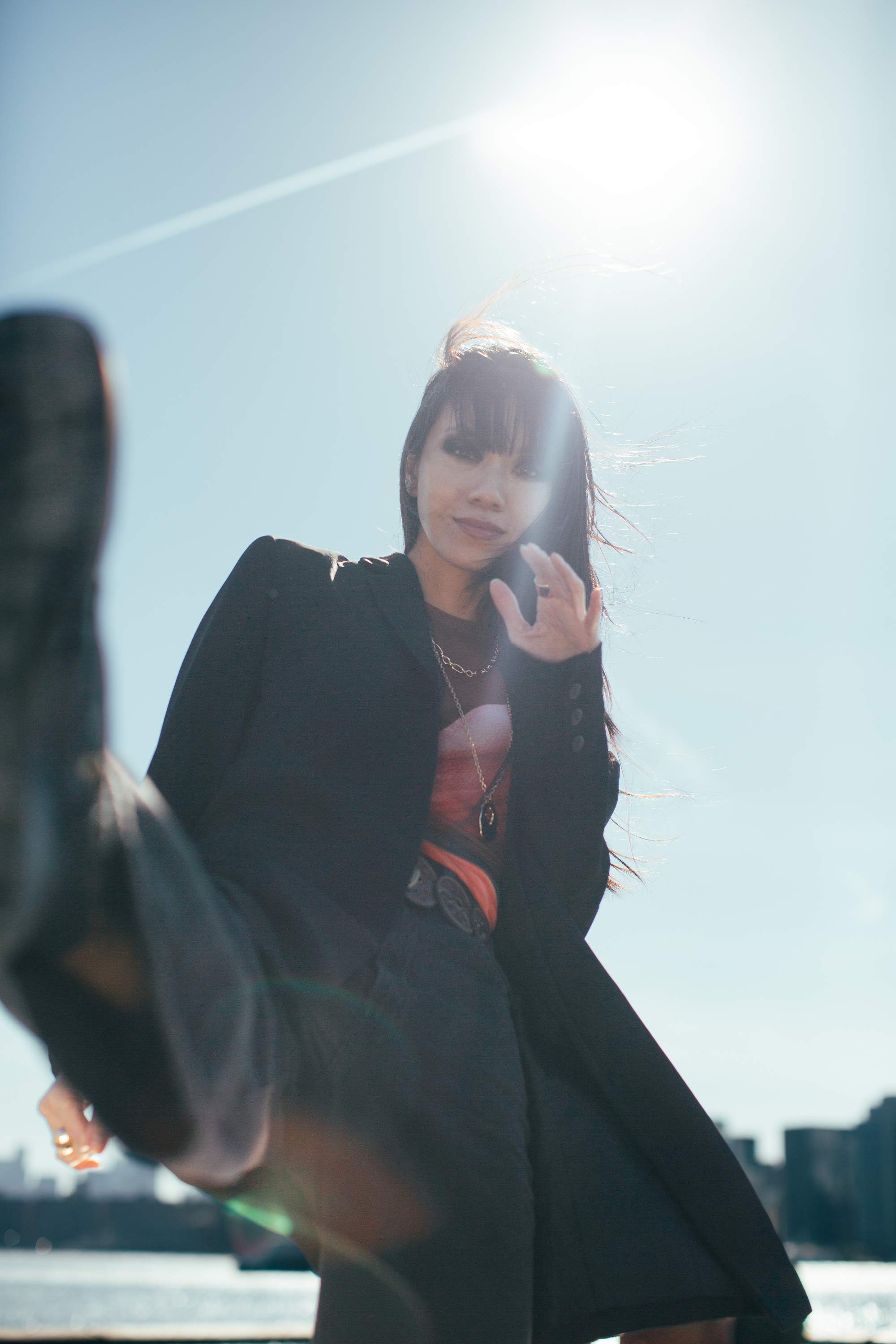 Darin Apinya dynamic fashion editorial kick pose NYC skyline